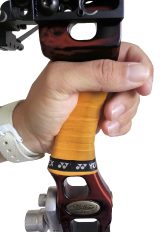 Your grip should rest on the ‘thumb pad’ part of your hand to ensure the bow has a solid footing